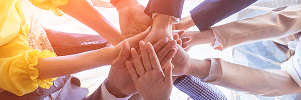 Underneath view of business people hands together concept.