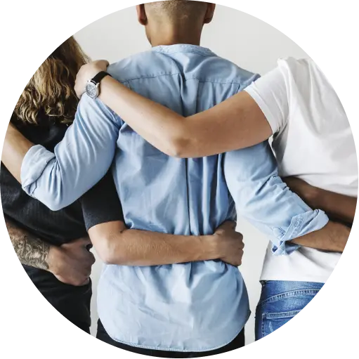 Colleagues standing together with their arms around one another